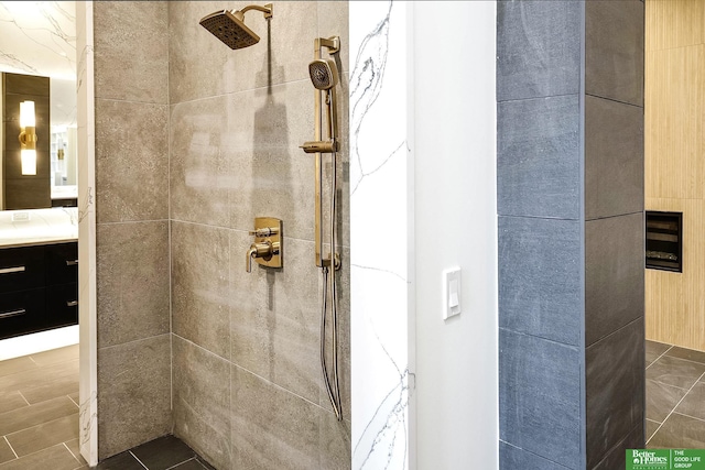 full bathroom with vanity and a tile shower