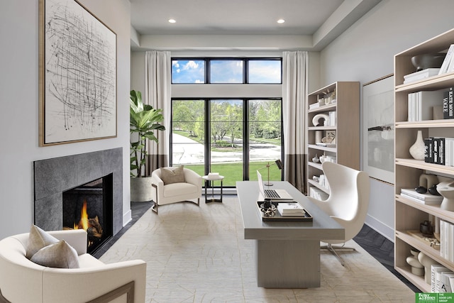 home office with recessed lighting, a high end fireplace, and a baseboard radiator