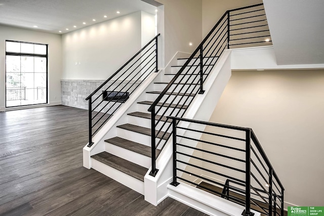 stairway with recessed lighting and wood finished floors