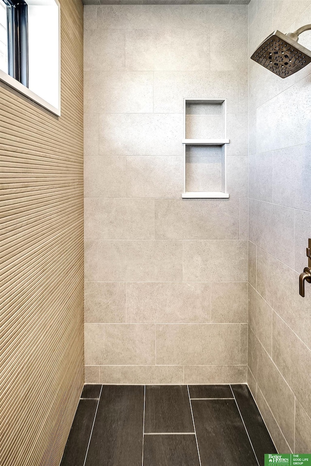 bathroom with a tile shower