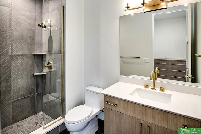 bathroom featuring vanity, a shower stall, and toilet