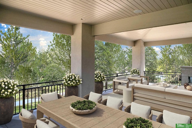 view of patio / terrace featuring a balcony and outdoor dining area