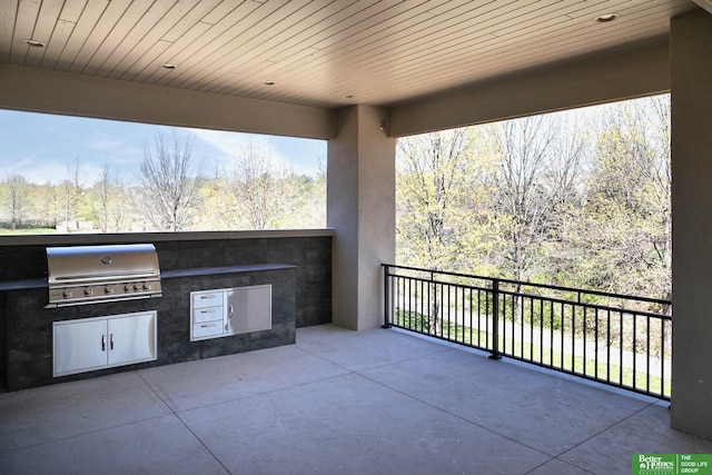 view of patio / terrace with area for grilling and a balcony