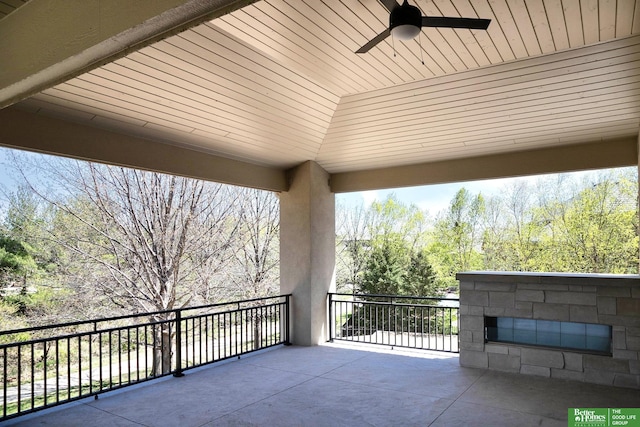 view of patio with a balcony and ceiling fan