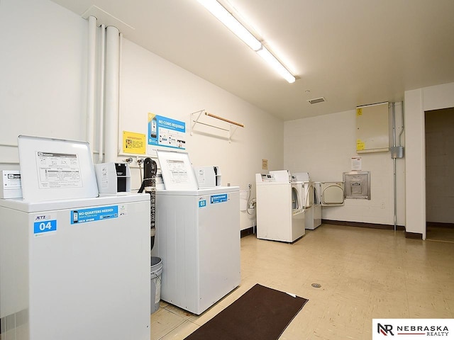 shared laundry area featuring visible vents, washing machine and dryer, and light floors