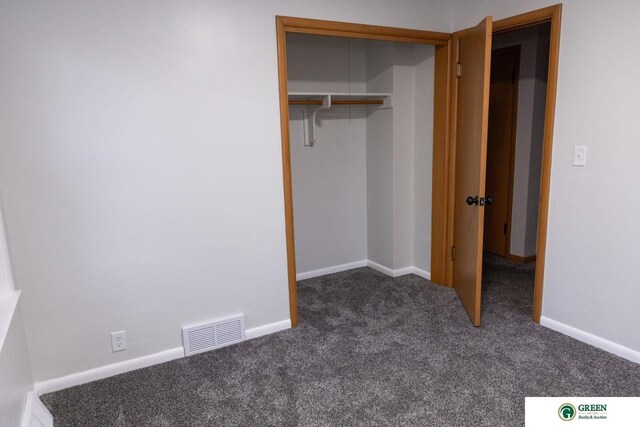 unfurnished bedroom with visible vents, carpet floors, baseboards, and a closet