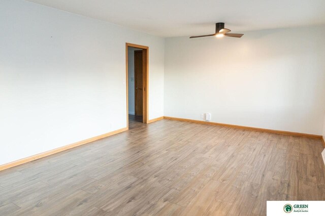 empty room with baseboards, light wood-type flooring, and ceiling fan