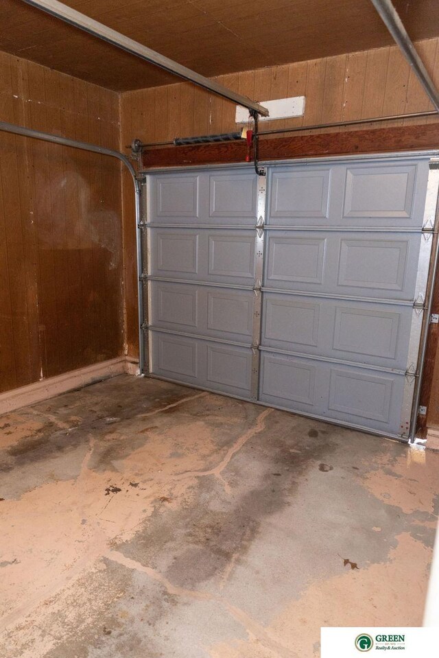 garage featuring wooden walls