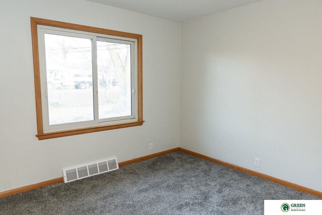 spare room featuring visible vents, carpet floors, and baseboards