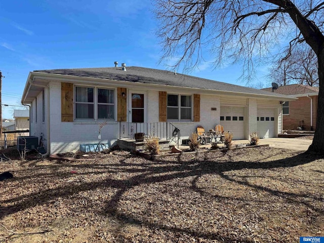 ranch-style home featuring brick siding, driveway, and an attached garage