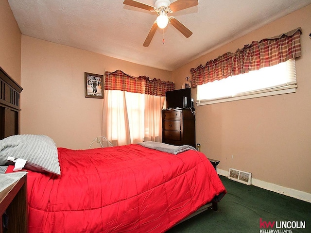 bedroom featuring visible vents, carpet flooring, baseboards, and ceiling fan