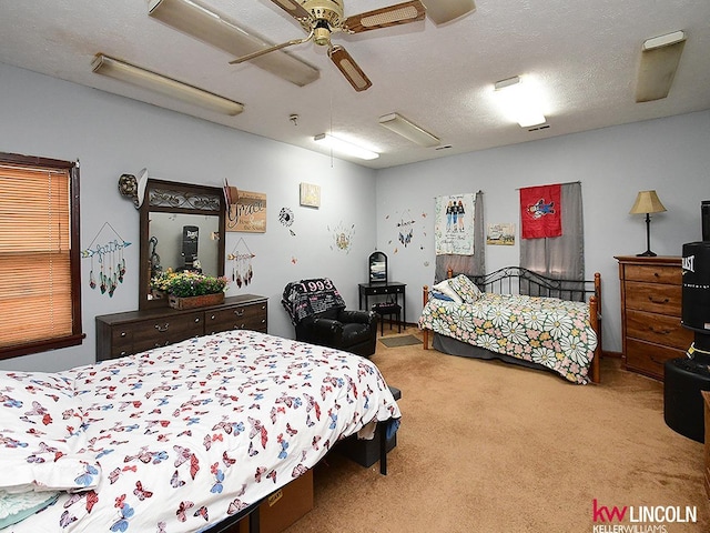 bedroom featuring ceiling fan, carpet flooring, and a textured ceiling