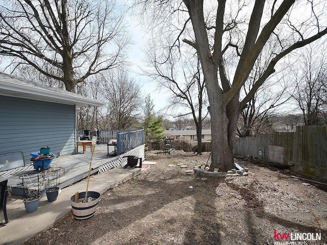 view of yard featuring a deck and fence