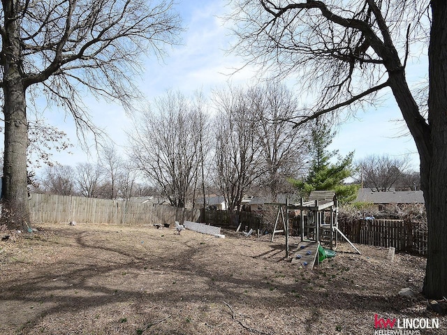 view of yard featuring fence private yard and a playground