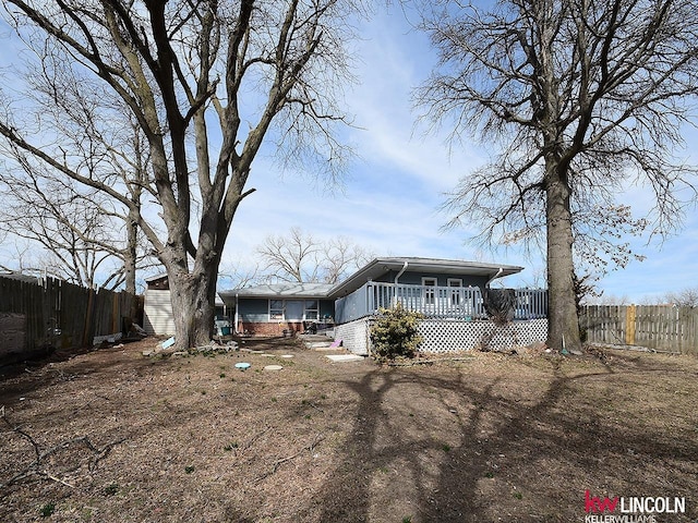 rear view of house with fence