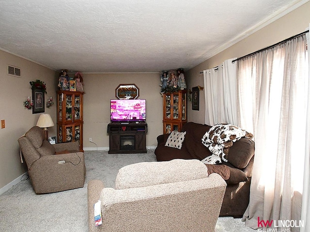 carpeted living room with visible vents, baseboards, a textured ceiling, and a fireplace