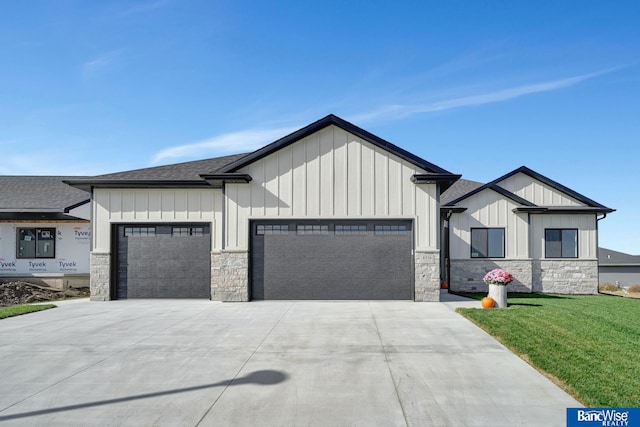 modern farmhouse style home with board and batten siding, concrete driveway, a front yard, roof with shingles, and a garage