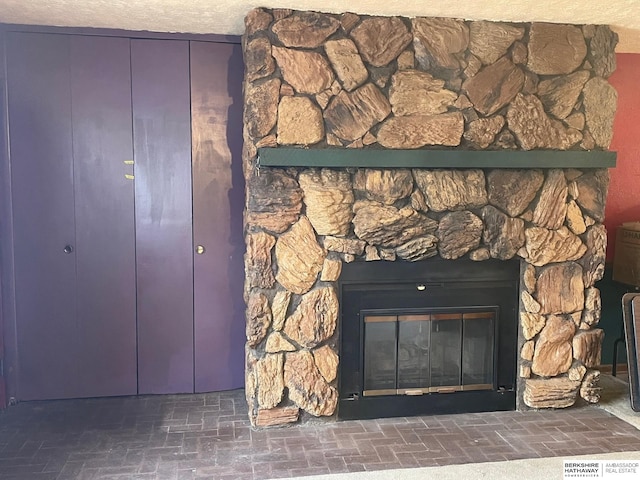 details with a stone fireplace and visible vents