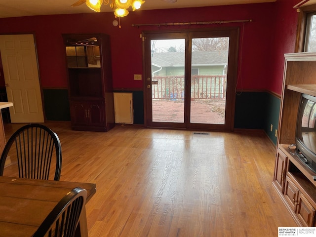 living area with visible vents and light wood finished floors