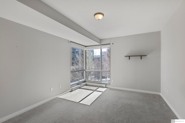 spare room with carpet and baseboards