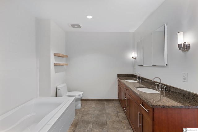 full bath with toilet, tiled tub, baseboards, and a sink