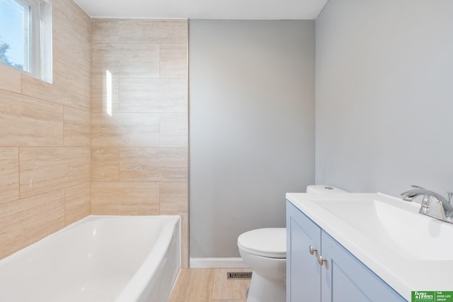 full bathroom featuring toilet, vanity, baseboards, and wood finished floors