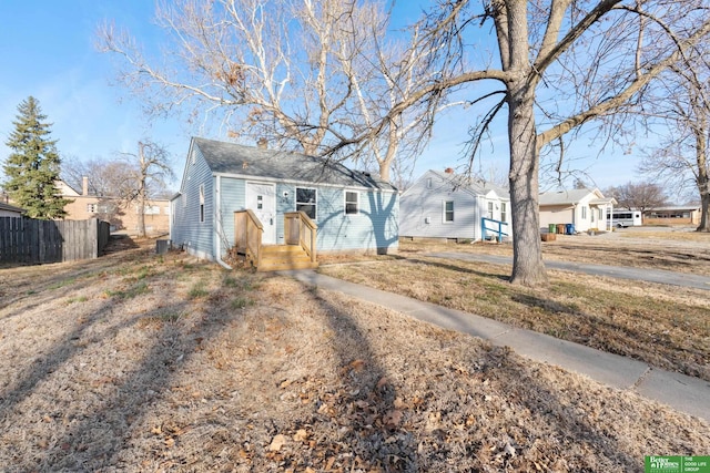 bungalow-style house featuring fence and a residential view