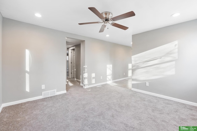 empty room featuring visible vents, baseboards, carpet floors, recessed lighting, and a ceiling fan