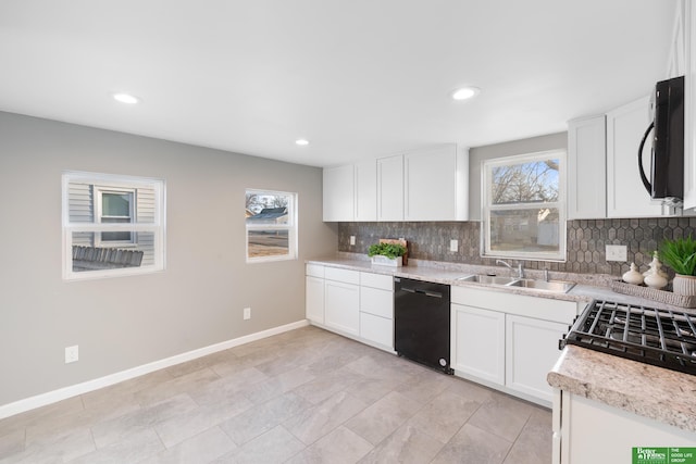 kitchen featuring backsplash, black appliances, baseboards, white cabinetry, and a sink