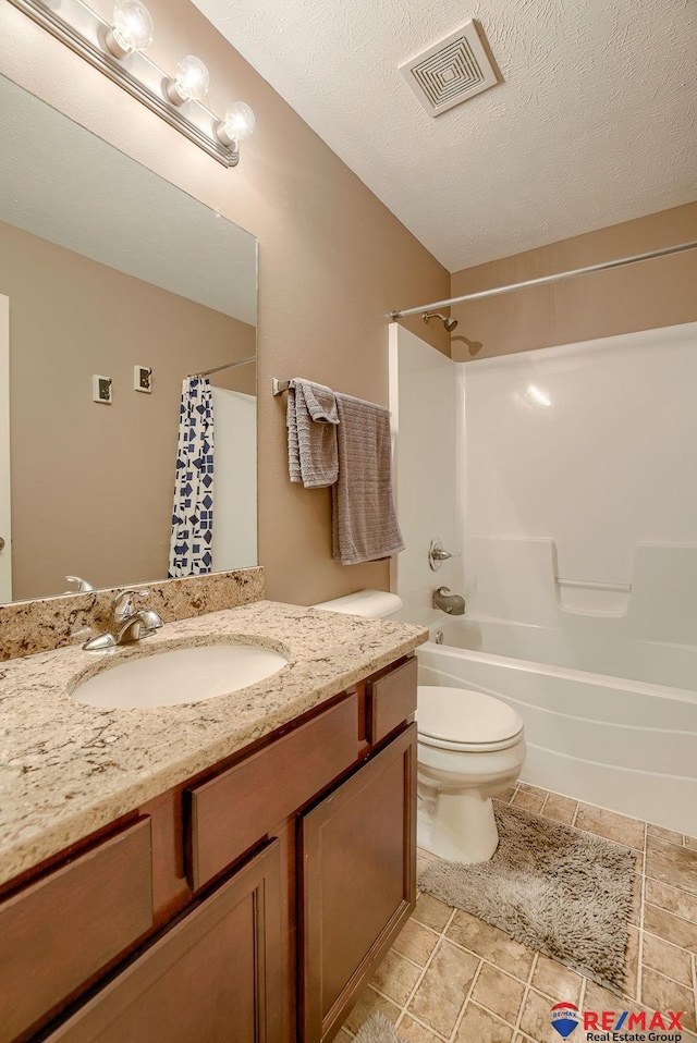 full bath with visible vents, toilet, vanity, shower / tub combo, and a textured ceiling