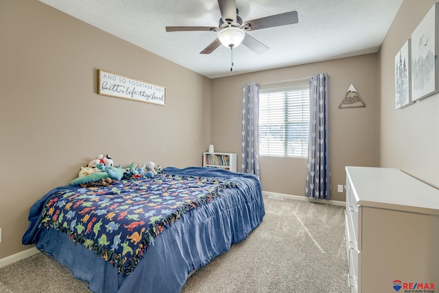 bedroom featuring a textured ceiling, baseboards, and light carpet