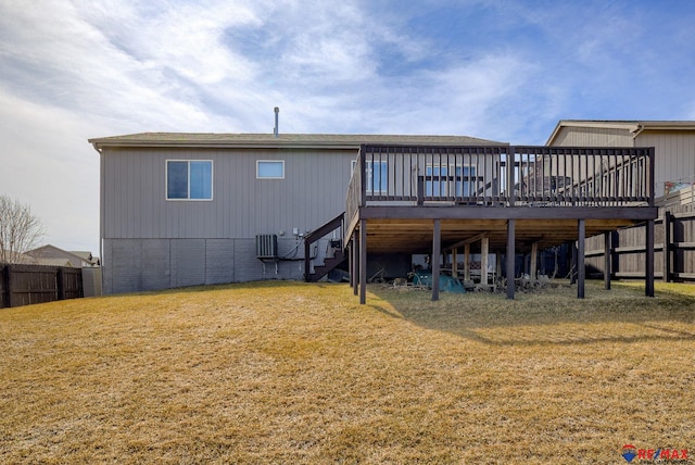 back of house featuring a deck, stairs, a yard, and fence