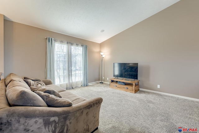 living area featuring baseboards, lofted ceiling, carpet, and a textured ceiling