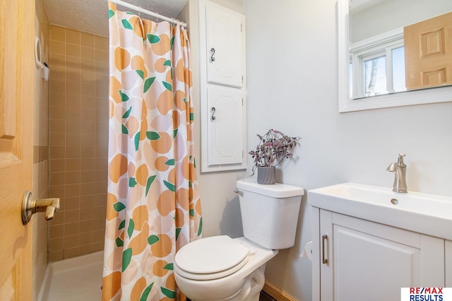 full bath with vanity, a textured ceiling, toilet, and tiled shower