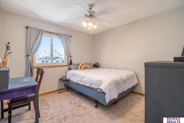 carpeted bedroom featuring baseboards and a ceiling fan