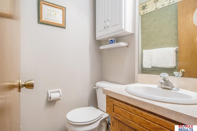 half bathroom with toilet and vanity