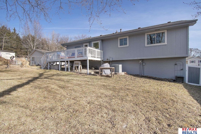 back of house featuring a wooden deck, central air condition unit, a lawn, and stairs