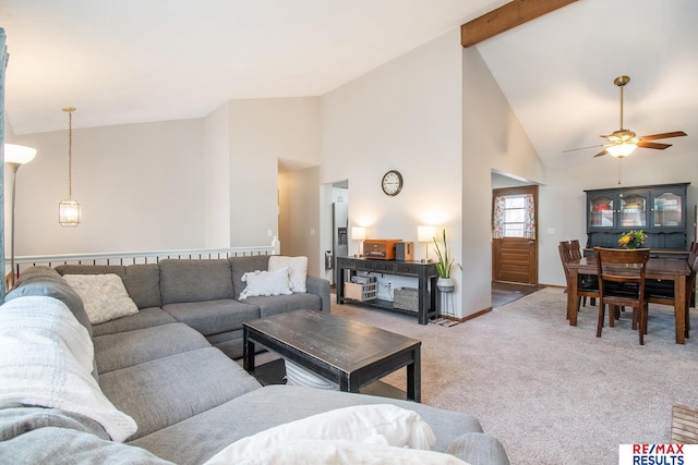 carpeted living room with beamed ceiling, high vaulted ceiling, and a ceiling fan