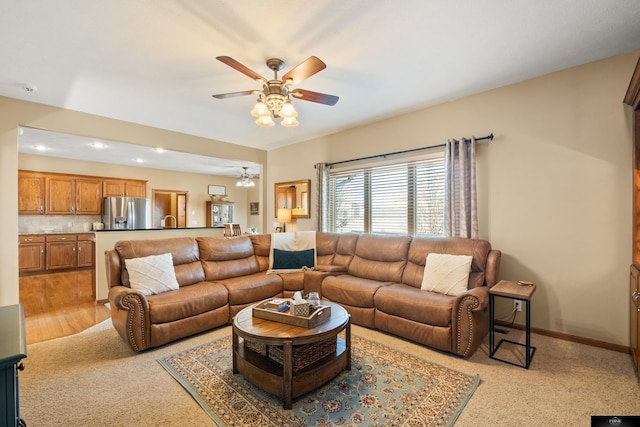 living area with light carpet, recessed lighting, baseboards, and ceiling fan