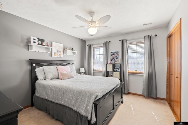 bedroom featuring light colored carpet, visible vents, and baseboards