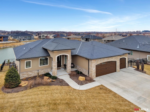 view of front facade featuring a residential view, concrete driveway, stucco siding, stone siding, and an attached garage