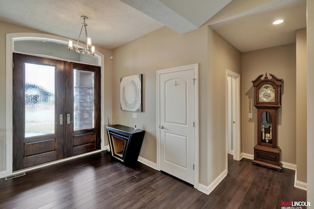 entryway featuring baseboards, visible vents, dark wood-type flooring, french doors, and a notable chandelier