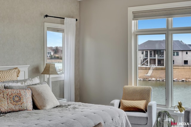 bedroom featuring a water view