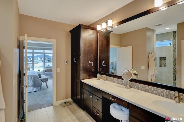 full bath featuring tasteful backsplash, visible vents, ensuite bath, and a sink