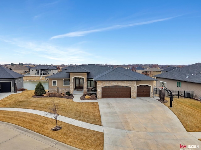 view of front of house with stone siding, french doors, a residential view, concrete driveway, and a garage