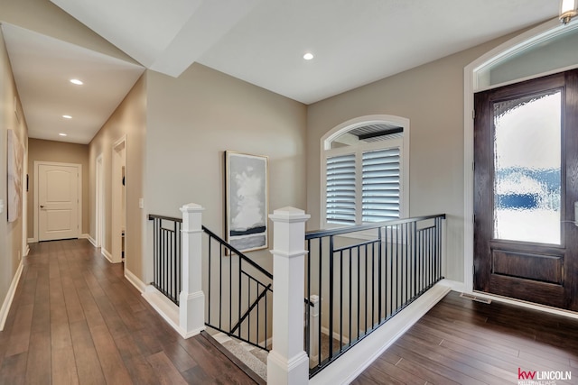 hallway with recessed lighting, an upstairs landing, baseboards, and wood-type flooring