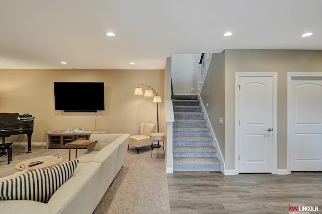 living area featuring stairs, wood finished floors, recessed lighting, and baseboards