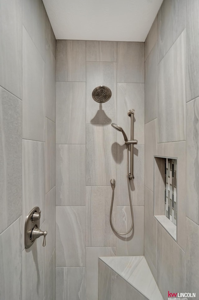 bathroom with a tile shower