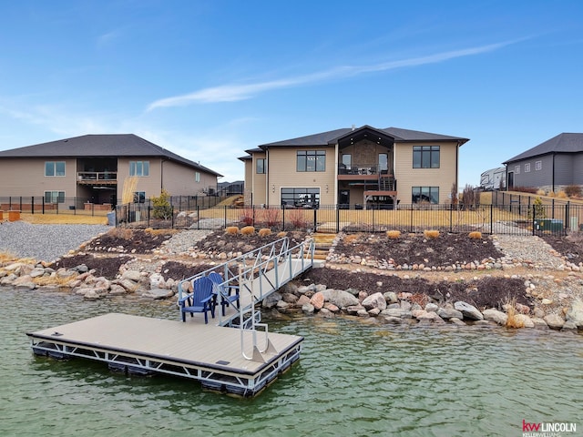 dock area featuring a water view and fence