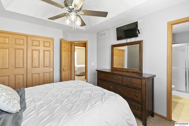 bedroom featuring visible vents, ceiling fan, a closet, light carpet, and connected bathroom